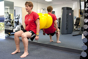 woman receiving post surgical rehab, strength training